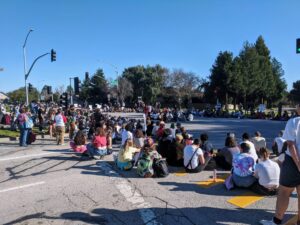 Students sit in a circle listening to speakers during UCSC grad student strike picket on Feb. 10, 2020